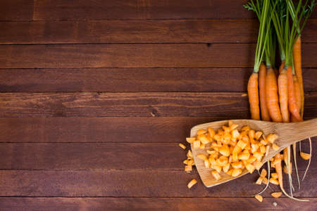 Freshly washed whole carrots on old wooden table. Copy space to right.の写真素材