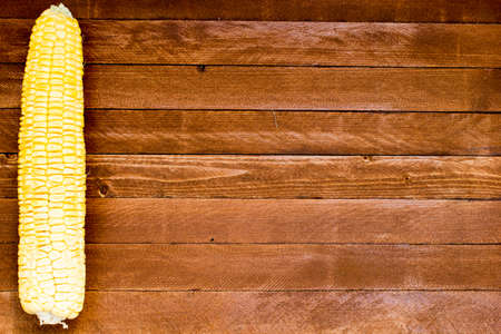 Grains of ripe corn on wooden background, copy spaceの写真素材