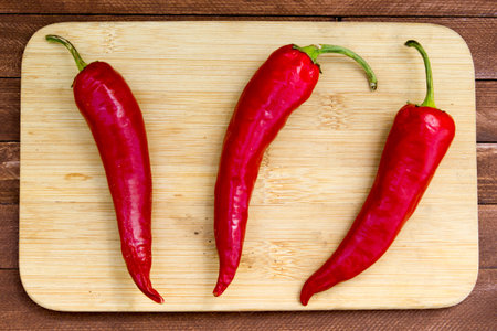 Red hot chili peppers on old wooden table