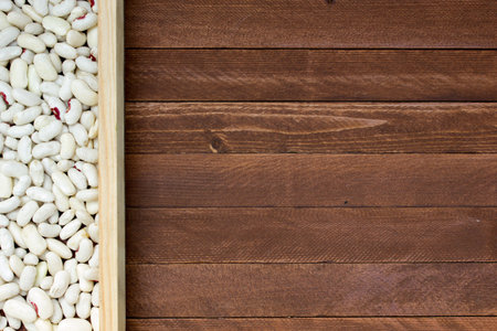 white beans on a wooden table, copy space