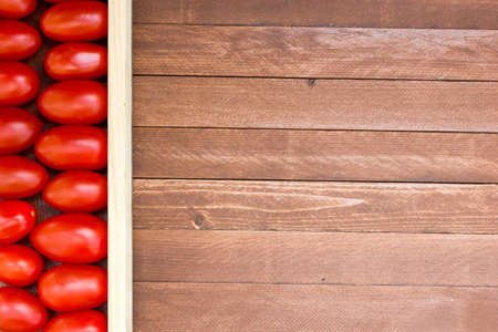 Close-up of fresh, ripe tomatoes on wood background, copy spaceの写真素材