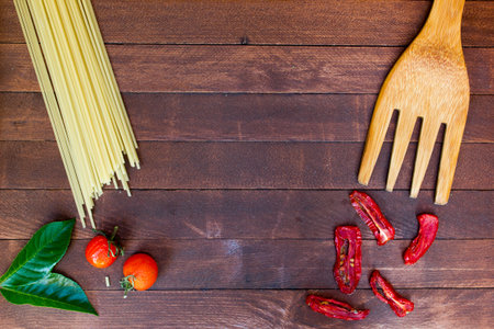 spaghetti and vegetables on wooden table background with copy spaceの写真素材