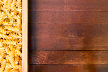 Italian pasta on wooden tableの写真素材