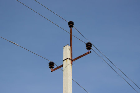 High voltage post. High-voltage tower sky background. power lines of blue sky at sunny autumn day.