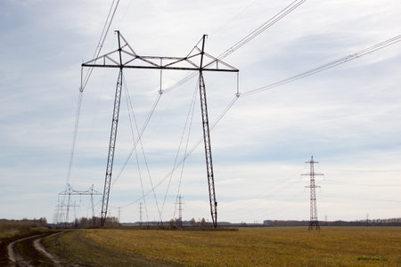 High voltage post. High-voltage tower sky background. power lines in field.