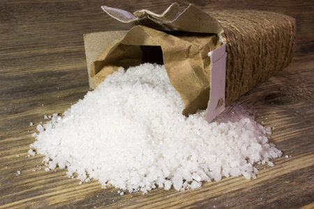 Large sea salt on wooden background