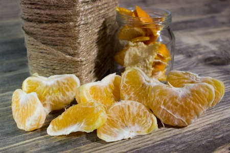 Mandarin slices on wooden backgroundの写真素材