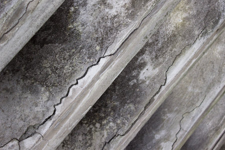 Concrete grey wall with cracks closeupの写真素材