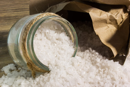 Large sea salt on wooden background