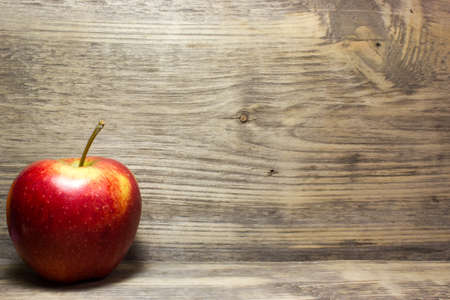 Red Apple on wooden backgroundの写真素材