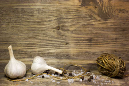 Garlic and spices on wooden background. Free space for text.の写真素材
