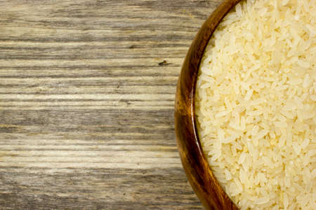 Grains of rice in wooden plateの写真素材