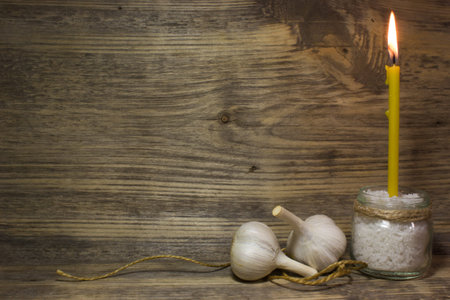 Church burning candle on wooden background