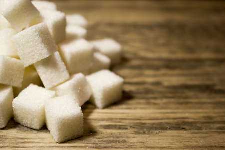 Sugar cubes on wooden backgroundの写真素材