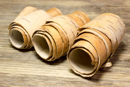 Rolls of birch Bark on woodenの写真素材
