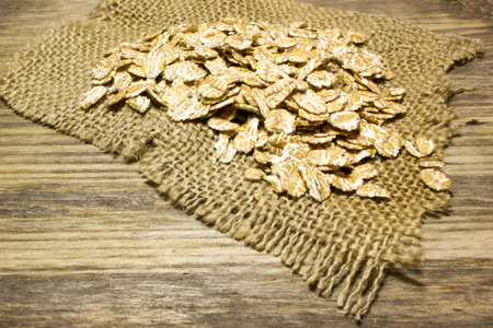 Wheat flakes on wooden backgroundの写真素材