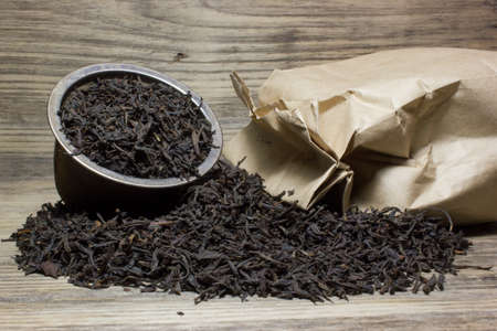 Dry tea leaves for black tea on wooden backgroundの写真素材