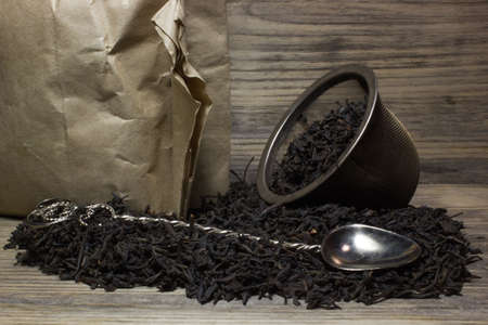 Dry tea leaves for black tea on wooden backgroundの写真素材