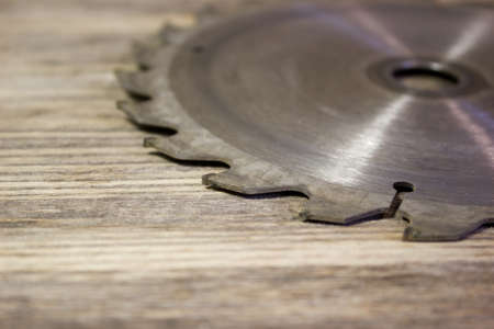 Drive circular saw on wooden backgroundの写真素材