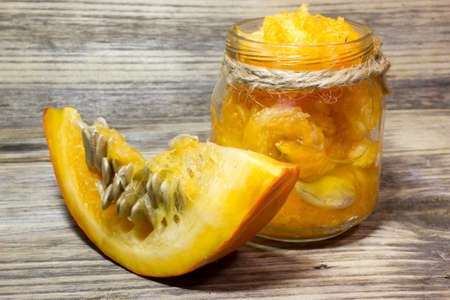 Cut slices of pumpkin seeds on wooden backgroundの写真素材