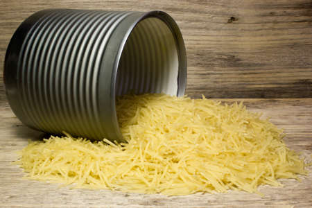 Small dry pasta noodles in tin on wooden backgroundの写真素材
