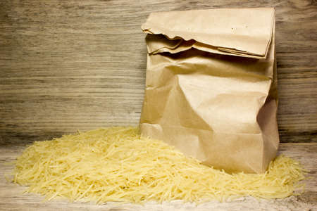 Small dry pasta noodles on wooden backgroundの写真素材