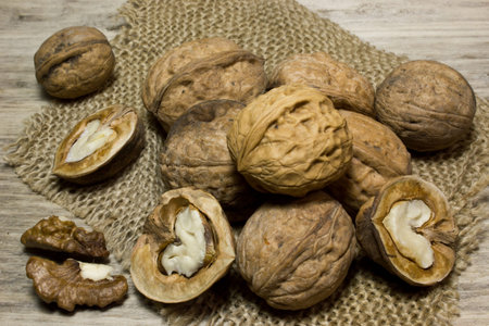 Walnut in shell on wooden background