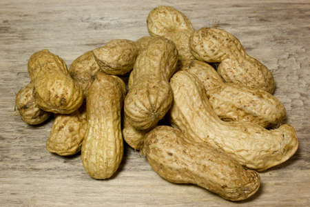 Peanuts in shell on wooden backgroundの写真素材