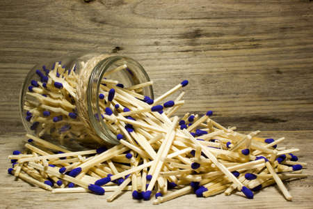 Matches with blue heads in jar on wooden backgroundの写真素材