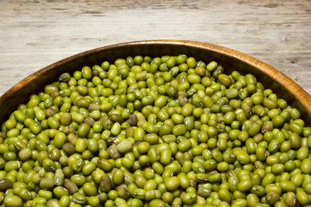 Green mung beans on a wooden background