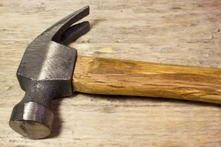 Hammer on wooden background