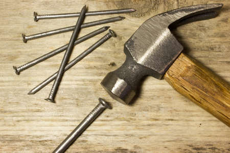 The hammer and nails on wooden backgroundの写真素材