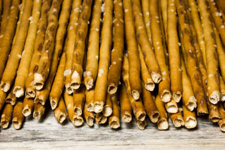 Bread sticks with salt on wooden backgroundの写真素材