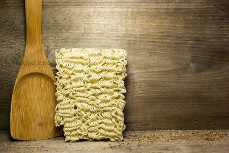 Instant noodles on wooden background