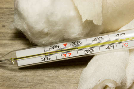 Medical thermometer on wooden background.の写真素材