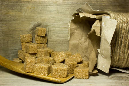 Cubes brown cane sugar on wooden backgroundの写真素材