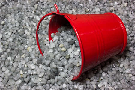 Gray gravel for construction and red bucketの写真素材