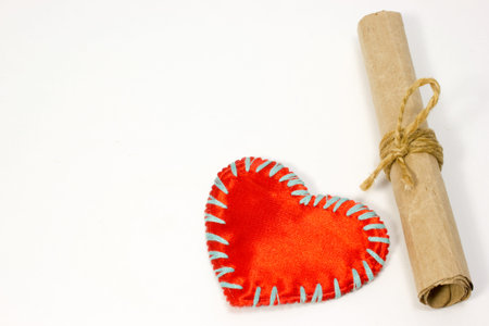Scroll and red heart on white