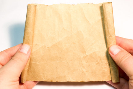 The sheet of parchment in hand on white background