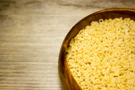 Noodle letters on wooden backgroundの写真素材