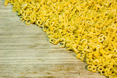 Noodle letters on wooden backgroundの写真素材