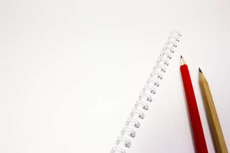 Notebook and pencil on white backgroundの写真素材