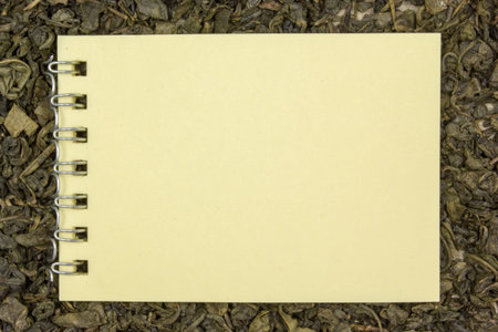 Dry green tea, a blank sheet of paper. Place for text