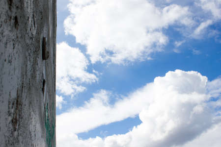 Concrete wall and sky with cloudsの写真素材