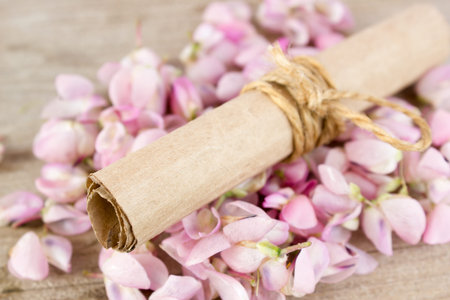 The flowers are lupine and paper scroll on wooden background