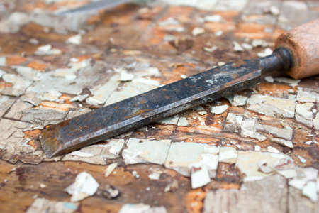 Old chisel on a wooden tableの写真素材