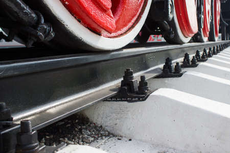 The red wheels of the locomotive on the railの写真素材