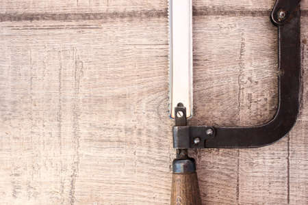Metal saw on woodの写真素材