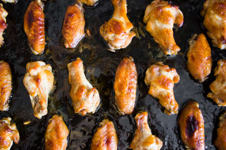 Grilled chicken wings on the black panの写真素材