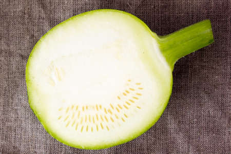 Round green zucchini on a wooden tableの写真素材